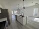 Modern kitchen featuring white cabinets, stainless steel appliances, and an island at 702 Marion Oaks Manor, Ocala, FL 34473