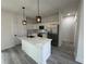 Modern kitchen with white cabinets, stainless steel appliances, and a kitchen island at 702 Marion Oaks Manor, Ocala, FL 34473