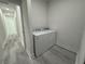Bright laundry room with white Whirlpool washer and dryer at 702 Marion Oaks Manor, Ocala, FL 34473