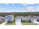 Three houses with gray roofs and green lawns; aerial view at 7149 Dilly Lake Ave, Groveland, FL 34736