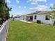 Spacious backyard featuring a manicured lawn, patio, and fenced perimeter at 7149 Dilly Lake Ave, Groveland, FL 34736