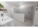 Modern bathroom with dual sinks, granite counters, and a walk-in shower at 7149 Dilly Lake Ave, Groveland, FL 34736