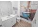 Charming bathroom with a unique shower curtain and a white vanity at 7149 Dilly Lake Ave, Groveland, FL 34736