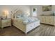 Comfortable bedroom featuring a stylish bed frame, matching dresser, and coordinating decor accents at 7149 Dilly Lake Ave, Groveland, FL 34736