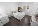 Bright and airy bedroom with white decor, laminate flooring, and a large window at 7149 Dilly Lake Ave, Groveland, FL 34736