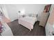 Cozy bedroom with white walls, dark floors, and ample natural light at 7149 Dilly Lake Ave, Groveland, FL 34736