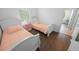 Bedroom with two beds and dark wood floors at 7149 Dilly Lake Ave, Groveland, FL 34736