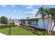Community clubhouse with landscaping and palm trees at 7149 Dilly Lake Ave, Groveland, FL 34736