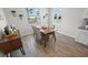Comfortable dining area is framed by bright windows and features a wooden table with seating for four at 7149 Dilly Lake Ave, Groveland, FL 34736