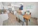 Dining area with wood table and chairs, open to kitchen and living room at 7149 Dilly Lake Ave, Groveland, FL 34736