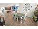 Dining area featuring a Gathering photo collage, wood-look tile flooring, a table with six chairs, and natural lighting at 7149 Dilly Lake Ave, Groveland, FL 34736