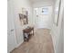 Entryway featuring wood flooring and table with decorative accents and a mirror at 7149 Dilly Lake Ave, Groveland, FL 34736