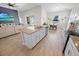 Open-concept kitchen with stainless steel appliances, island with breakfast bar, and adjacent dining area at 7149 Dilly Lake Ave, Groveland, FL 34736