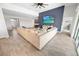 Spacious living room with modern decor, a large sectional sofa, and a feature wall with a TV at 7149 Dilly Lake Ave, Groveland, FL 34736