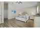 Spacious main bedroom with vaulted ceiling, TV, and ensuite bathroom at 7149 Dilly Lake Ave, Groveland, FL 34736