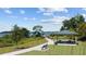 Scenic park view with covered picnic area, benches, and a walking path with lake views at 7149 Dilly Lake Ave, Groveland, FL 34736