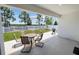 Relaxing covered patio with outdoor dining furniture and gas grill at 7149 Dilly Lake Ave, Groveland, FL 34736