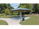 Shaded picnic area featuring picnic tables and a trash can among natural landscaping at 7149 Dilly Lake Ave, Groveland, FL 34736