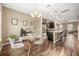 Dining area with glass table, chandelier, and open kitchen access at 7236 Shadeview Aly, Windermere, FL 34786