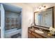 Bathroom with granite vanity, tub shower, and tile flooring at 7609 Heritage Crossing Way # 201, Reunion, FL 34747