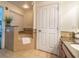 Spa-like bathroom with soaking tub and granite vanity at 7609 Heritage Crossing Way # 201, Reunion, FL 34747