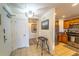 Bright and spacious entryway with wood-look flooring and access to kitchen at 7609 Heritage Crossing Way # 201, Reunion, FL 34747