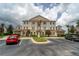 Building exterior with ample parking and attractive landscaping at 7609 Heritage Crossing Way # 201, Reunion, FL 34747