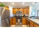 Well-equipped kitchen, stainless steel appliances, granite countertops at 7609 Heritage Crossing Way # 201, Reunion, FL 34747