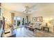 Relaxing living room with light colored furniture and hardwood floors at 7609 Heritage Crossing Way # 201, Reunion, FL 34747