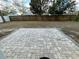Paver patio in a backyard enclosed by a wooden fence and mature trees creating a relaxing outdoor space at 7839 Murcott Cir, Orlando, FL 32835
