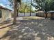 A spacious backyard featuring a patio area and both wood and white fences, perfect for outdoor activities at 7839 Murcott Cir, Orlando, FL 32835