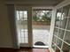 View from inside looking to the patio and fenced backyard, accessible through glass doors at 7839 Murcott Cir, Orlando, FL 32835