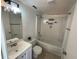 Bright bathroom with a tub and shower combination, vanity with sink and a decorative light fixture at 7839 Murcott Cir, Orlando, FL 32835