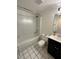 Well-lit bathroom with a shower-tub combination and tile flooring, offering a clean and functional space at 7839 Murcott Cir, Orlando, FL 32835