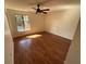 An empty bedroom featuring a ceiling fan, neutral walls, and a window providing natural light at 7839 Murcott Cir, Orlando, FL 32835