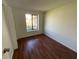 Cozy bedroom with a large window, wood floors, and neutral decor at 7839 Murcott Cir, Orlando, FL 32835