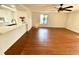 Open concept living room featuring wood floors and a breakfast bar overlooking the kitchen at 7839 Murcott Cir, Orlando, FL 32835