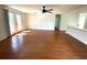 Hardwood living room with a ceiling fan and a sliding glass door to the backyard at 7839 Murcott Cir, Orlando, FL 32835