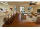 Open concept living room with hardwood floors and a breakfast bar overlooking the kitchen at 7839 Murcott Cir, Orlando, FL 32835