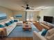 Staged living room with hardwood floors, bright furniture, and access to the backyard at 7839 Murcott Cir, Orlando, FL 32835