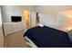 Cozy bedroom with double bed, dresser, and ensuite bathroom access at 840 Las Fuentes Dr, Kissimmee, FL 34746