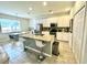 Modern kitchen with white cabinets, granite counters, and island at 840 Las Fuentes Dr, Kissimmee, FL 34746