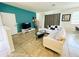 Living room with white sectional sofa and teal accent wall at 840 Las Fuentes Dr, Kissimmee, FL 34746