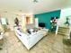 Living room with white sectional and a teal accent wall at 840 Las Fuentes Dr, Kissimmee, FL 34746