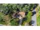 An aerial view showcasing a house nestled among lush trees at 847 Lake Charm Dr, Oviedo, FL 32765