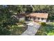 Aerial view of ranch-style home with a long driveway at 847 Lake Charm Dr, Oviedo, FL 32765