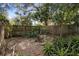Backyard with wooden fence and various plants at 847 Lake Charm Dr, Oviedo, FL 32765