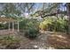 Landscaped backyard with stone pathway and lush foliage at 847 Lake Charm Dr, Oviedo, FL 32765