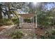 Backyard with pergola, stone patio, and lush landscaping at 847 Lake Charm Dr, Oviedo, FL 32765