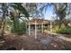 Relaxing backyard with pergola and mature trees at 847 Lake Charm Dr, Oviedo, FL 32765